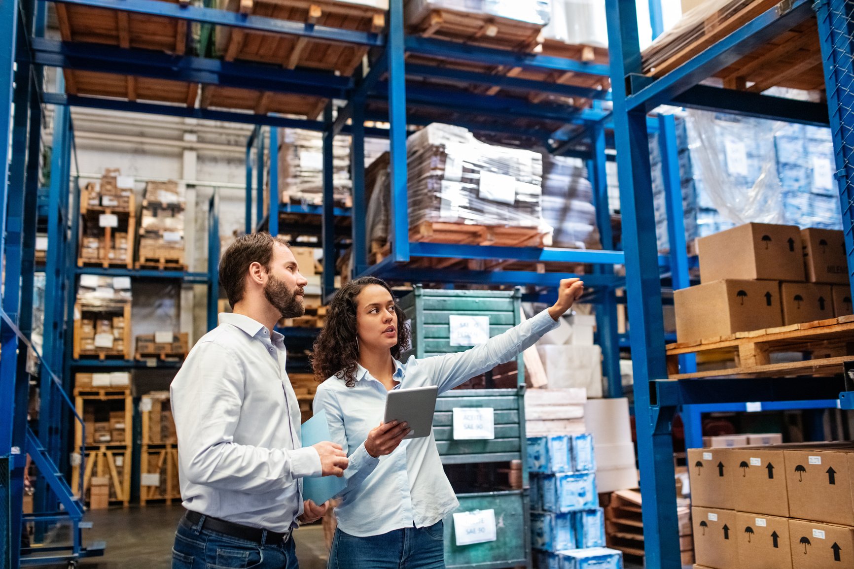 Manager and supervisor taking inventory in warehouse